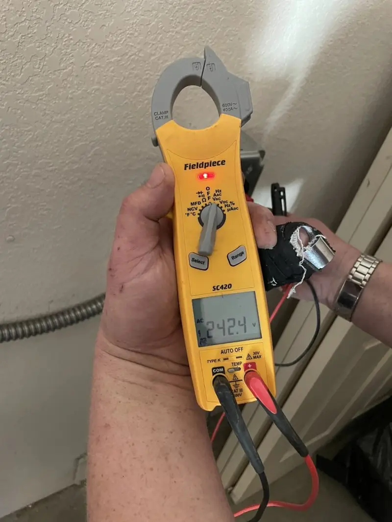 Voltage testing with clamp meter during Ceiling Fan Installation in Kiryas Joel